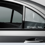 Custom waterproof decal on a car window displaying Instagram handle for promotional use.